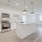 Spacious and well lit kitchen with wood flooring and stainless steel appliances