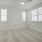 Large well lit bedroom with plush carpets and large windows 