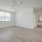Large well lit bedroom with wood floors and large windows 