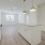 Spacious and well lit kitchen with wood flooring and stainless steel appliances
